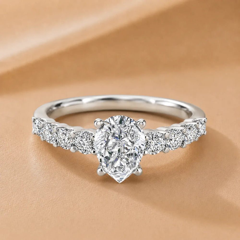 Elegant Solitaire Ring with Graduated Accent Stones – Pear (14K White Gold)